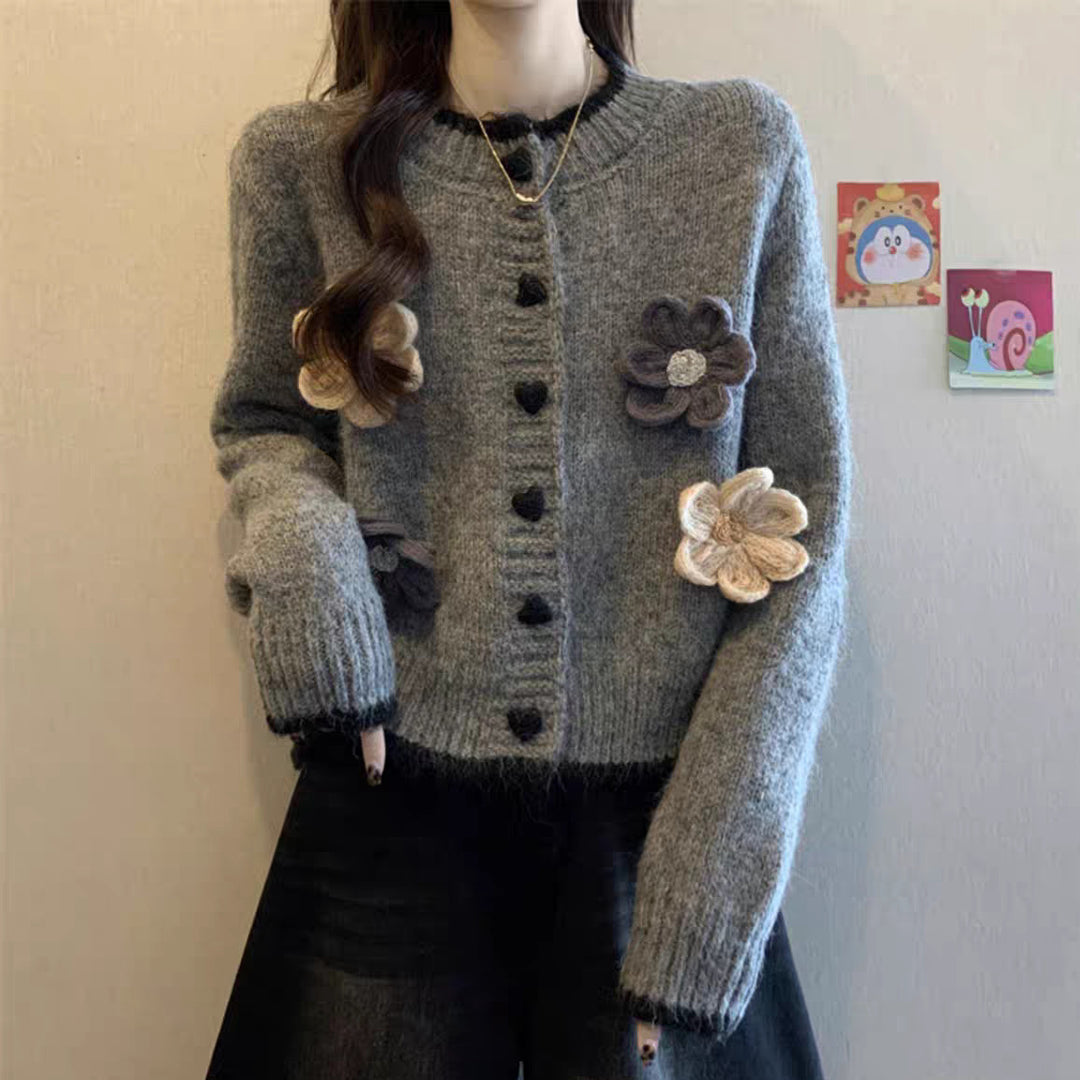 Ladies playful pullover with heart-shaped button closure and floral appliqués Lune London
