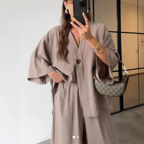 Ladies outfit consisting of an elegant V-neck blouse and wide palazzo pants Lune London
