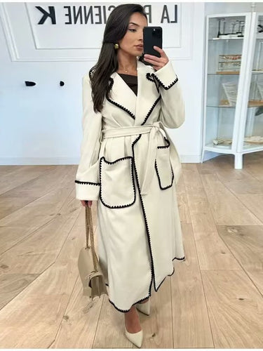 Elegant long coat for women with a tie belt and contrasting piping Lune London