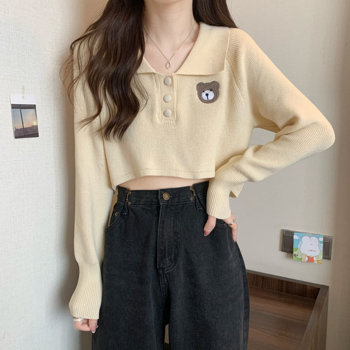 Women Cropped Pullover with a one-button closure and unicorn emblem