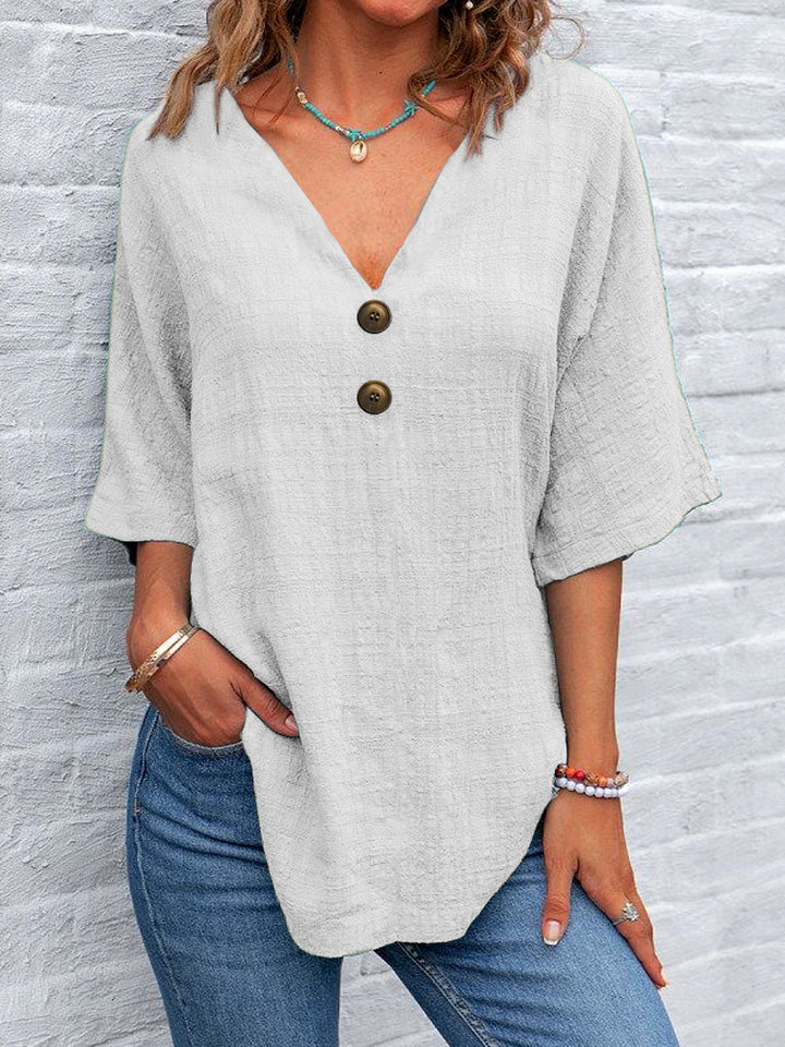 Ladies' V-neck blouse with decorative buttons and chic casual cut
