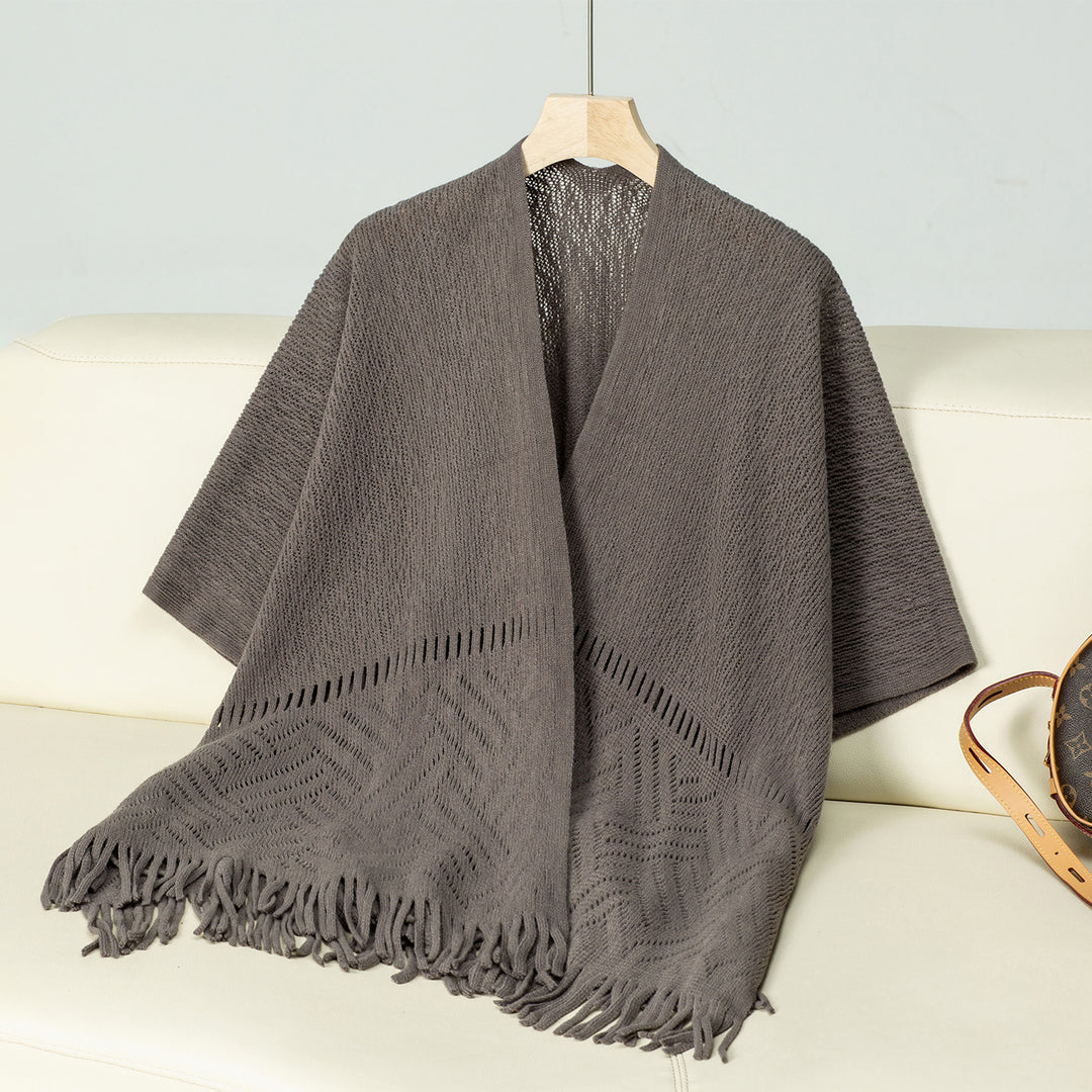Elegant knitted poncho for women with fringe details and a distinctive pattern Lune London