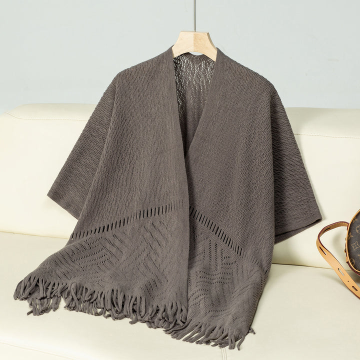 Elegant knitted poncho for women with fringe details and a distinctive pattern Lune London