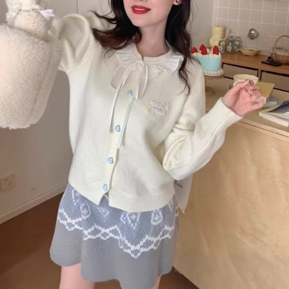 Ladies playful cardigan with ruffle detail and pearl-like buttons Lune London