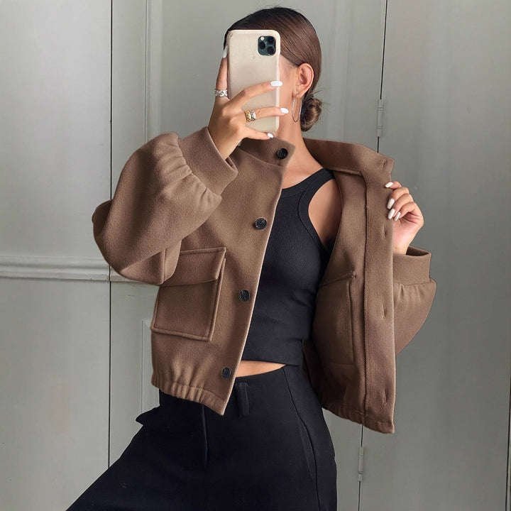Fashionable short jacket for women with practical flap pockets and a chic stand-up collar