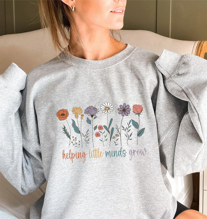 Sweat-shirt femme avec des manches volumineuses et un imprimé floral motivant Chic & Stil