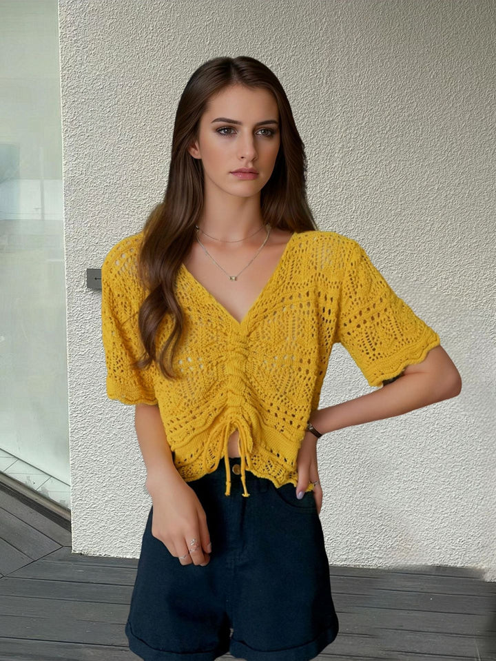 Women's knit top with decorative hole pattern and adjustable hem Lune London