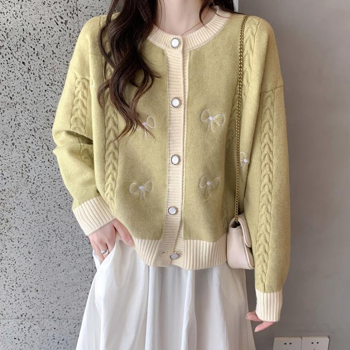 Ladies comfortable knitted cardigan with bow appliqués and a cable pattern Lune London