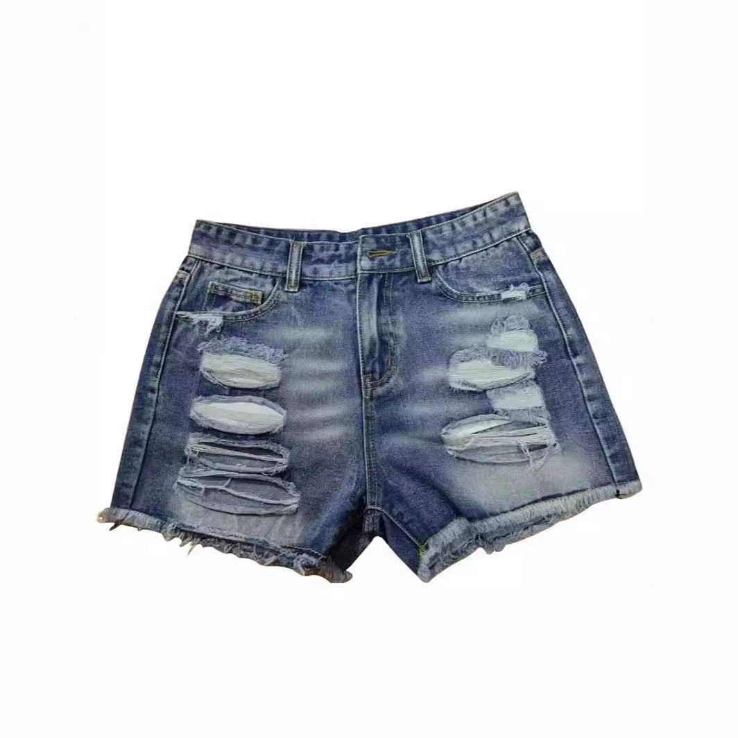Ladies trendy destroyed denim shorts with frayed hems and fashionable ripped details Lune London