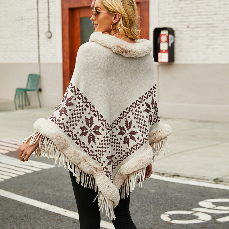 Elegant women's poncho with decorative fringe design and faux fur trim Lune London