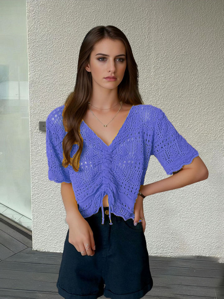 Women's knit top with decorative hole pattern and adjustable hem Lune London