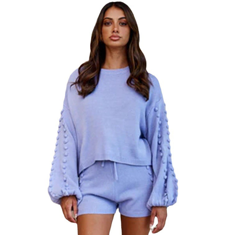 Trendy women's outfit consisting of an asymmetric sweater and shorts with decorative details Lune London
