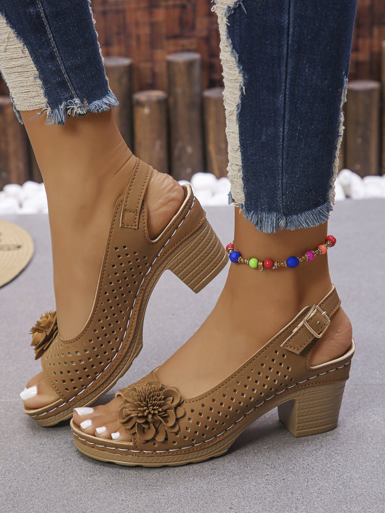 Women's clogs with a decorative floral detail and a perforated surface Lune London