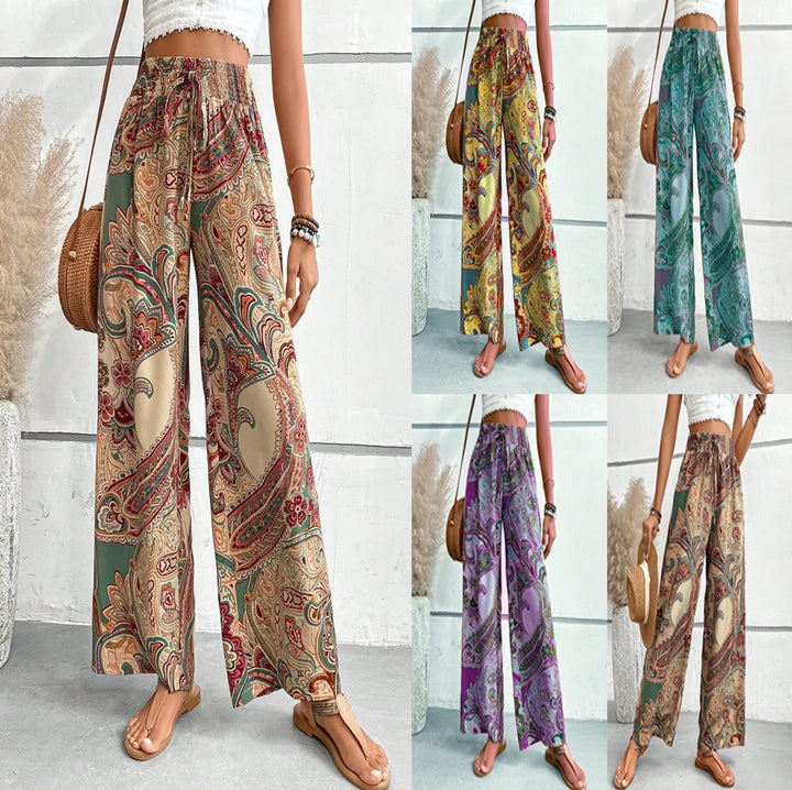 Wide palazzo pants for women with a colorful paisley pattern and an elastic waistband Lune London
