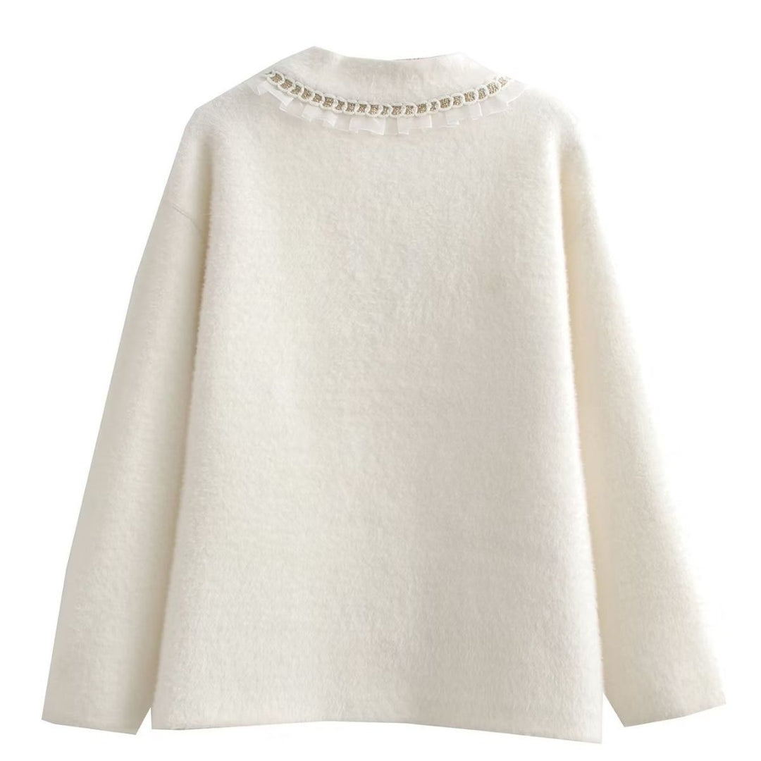 Fashionable women's knitted jacket with decorative ruffles and button details adorned with pearls Lune London