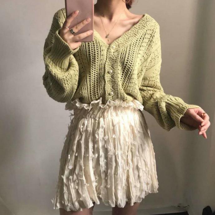 Thick knitted sweater for women with a trendy V-neck and chic button details