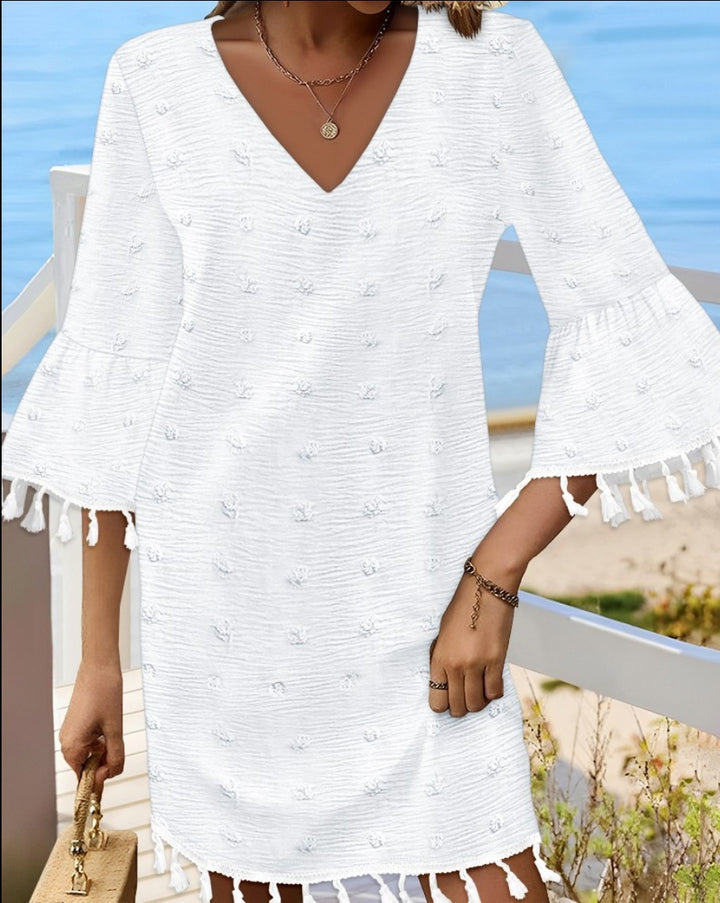 Beach dress for women with an elegant V-neckline and decorative fringes Lune London