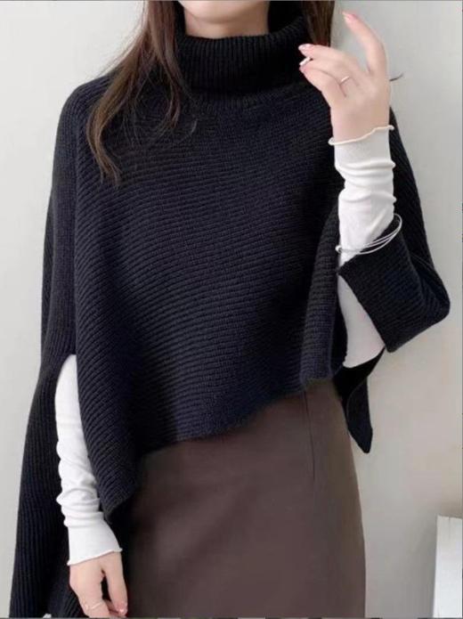 Ladies knitted poncho with high collar and asymmetrical cut Lune London