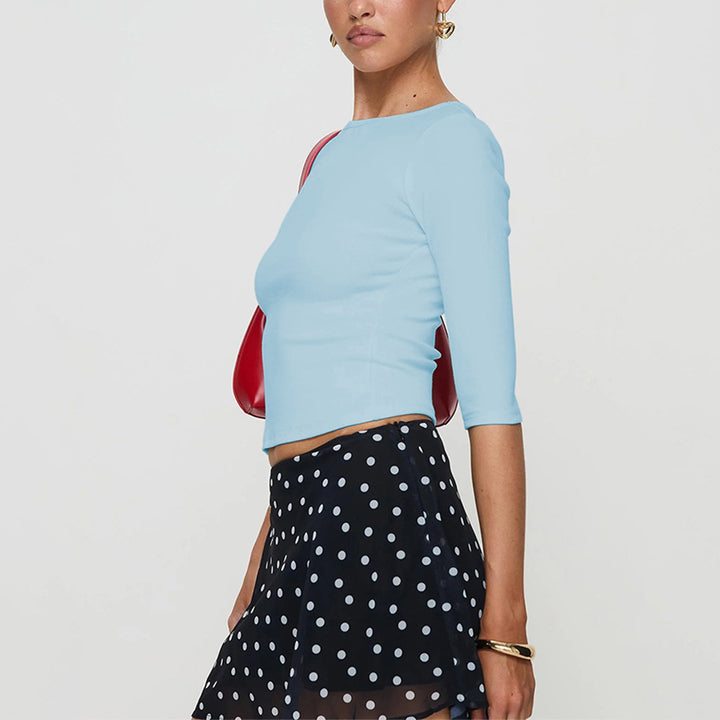 Chemise à manches longues coupée pour femmes avec un col rond élégant et une coupe flatteuse.