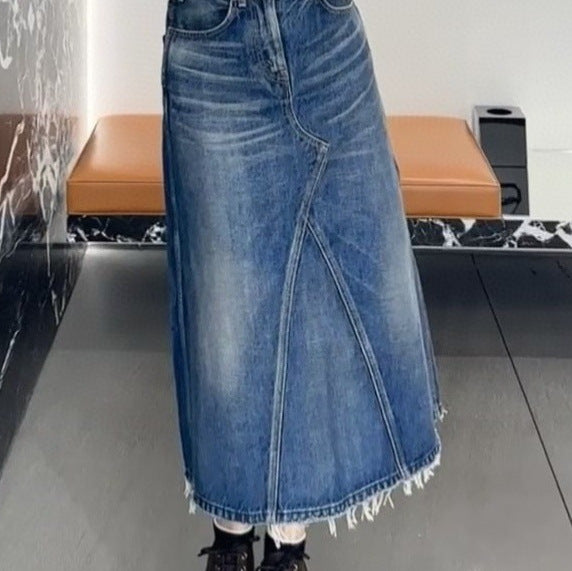 Women's maxi skirt in a casual denim style with asymmetrical hem and fringes Lune London