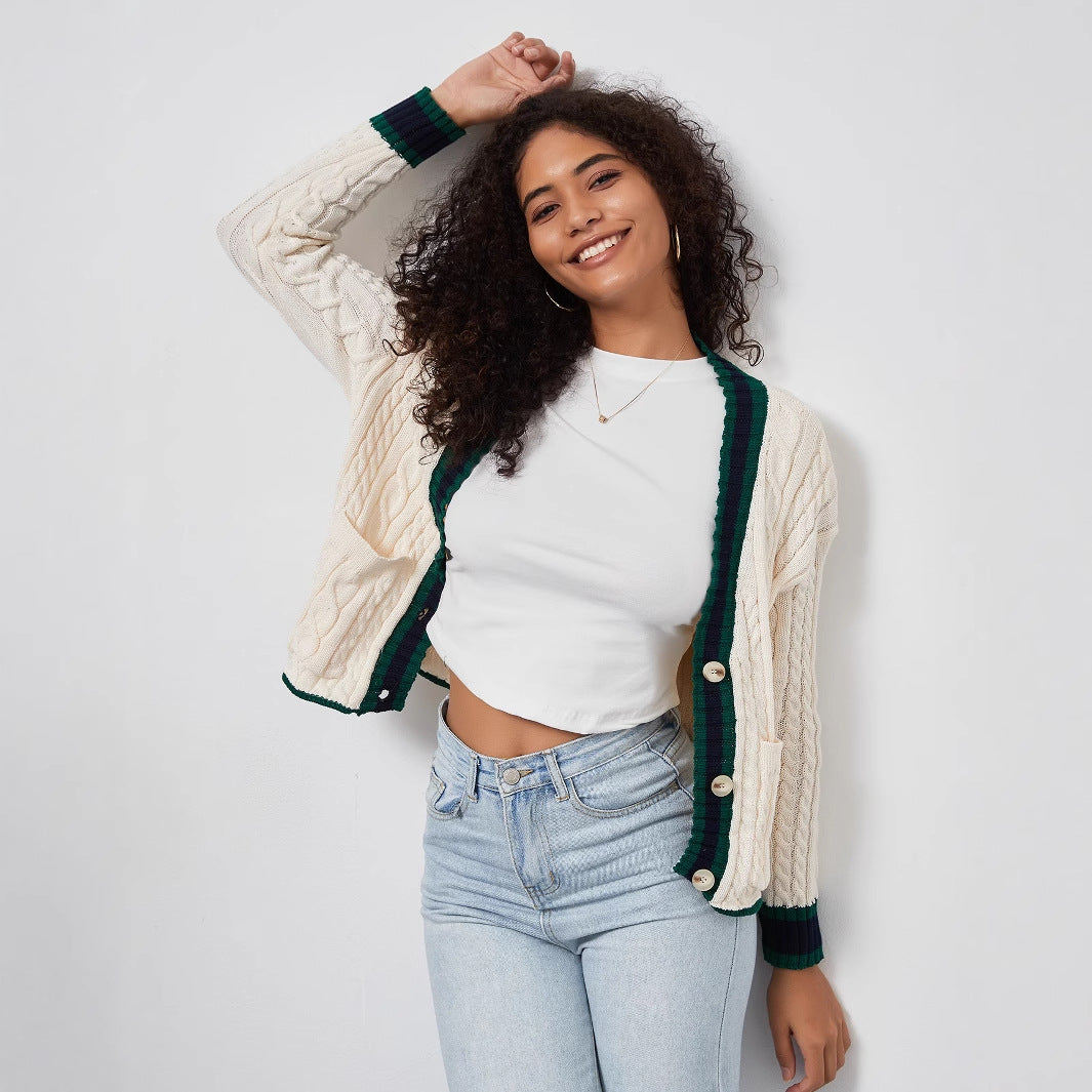Chunky knit cardigan for women with decorative button placket and matching hem.