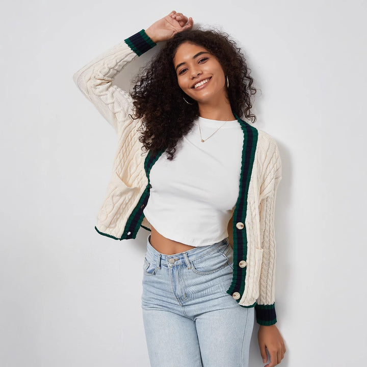 Chunky knit cardigan for women with decorative button placket and matching hem.