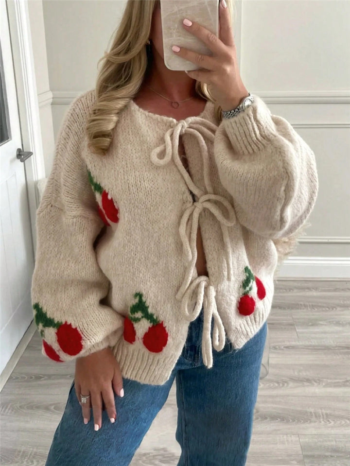 Women's knitted jacket with playful cherry pattern and decorative bows Lune London