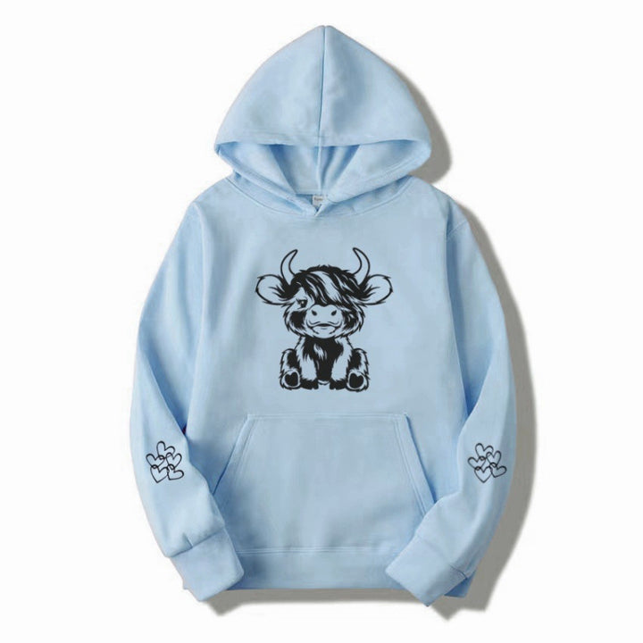 Women's hooded sweatshirt with charming cow motif and practical kangaroo pockets Lune London
