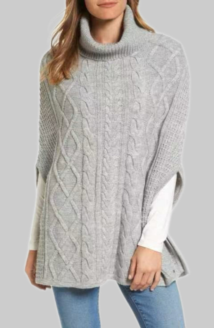 Knitted poncho for women with high collar and classic cable knit pattern Lune London