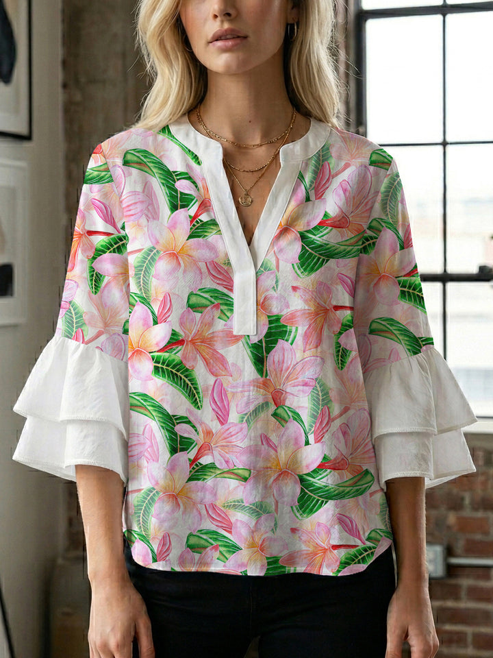 Women’s blouse with voluminous ruffled sleeves and floral pattern Lune London