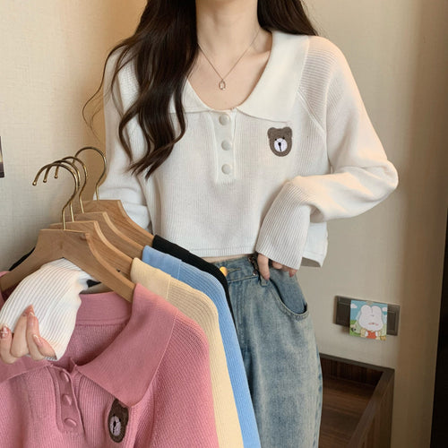 Women Cropped Pullover with a one-button closure and unicorn emblem