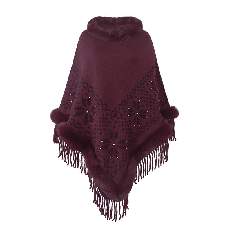 Elegant women's poncho with decorative fringe design and faux fur trim Lune London