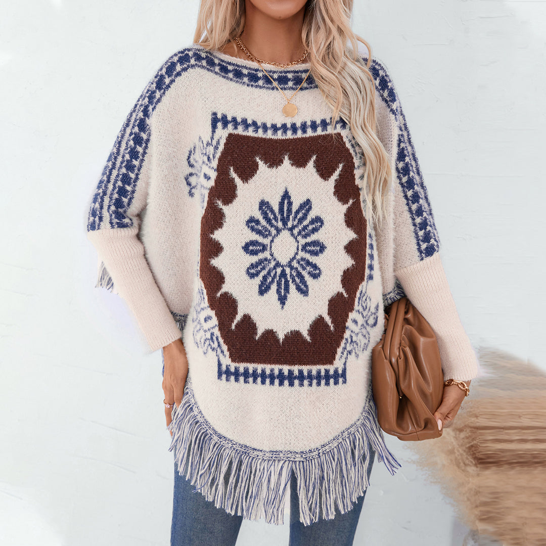 Ladies elegant knitted poncho with artistic pattern and fringe finish Lune London
