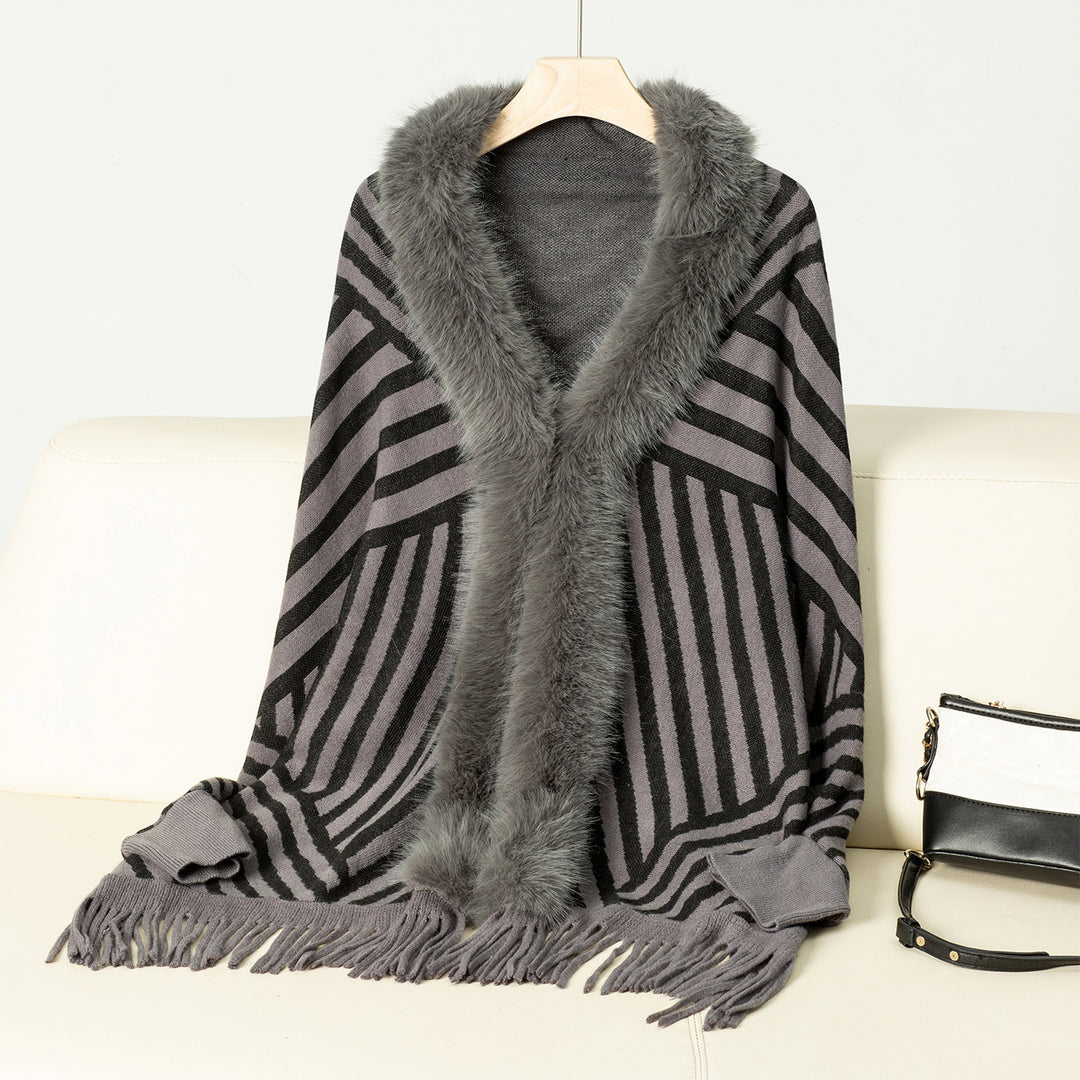 Ladies knitted poncho with elegant faux fur collar and fringe design Lune London
