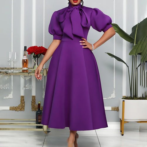 Elegant maxi dress for women with voluminous puff sleeves and a bow neckline Lune London