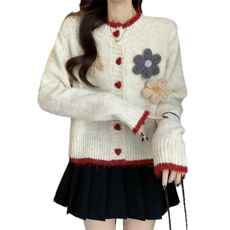 Ladies playful pullover with heart-shaped button closure and floral appliqués Lune London