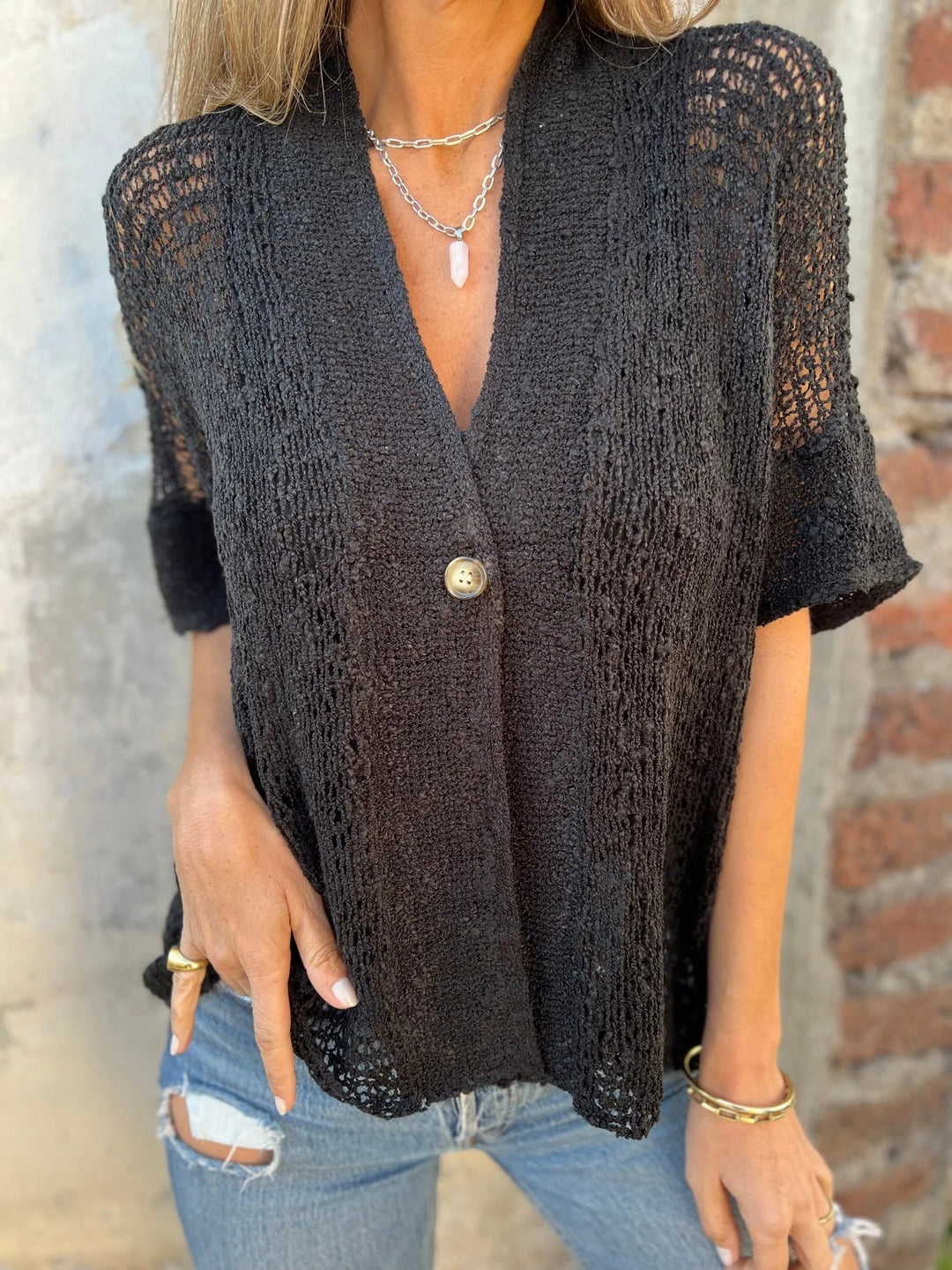 Knit blouse for women with modern openwork patterns and an elegant button front Lune London