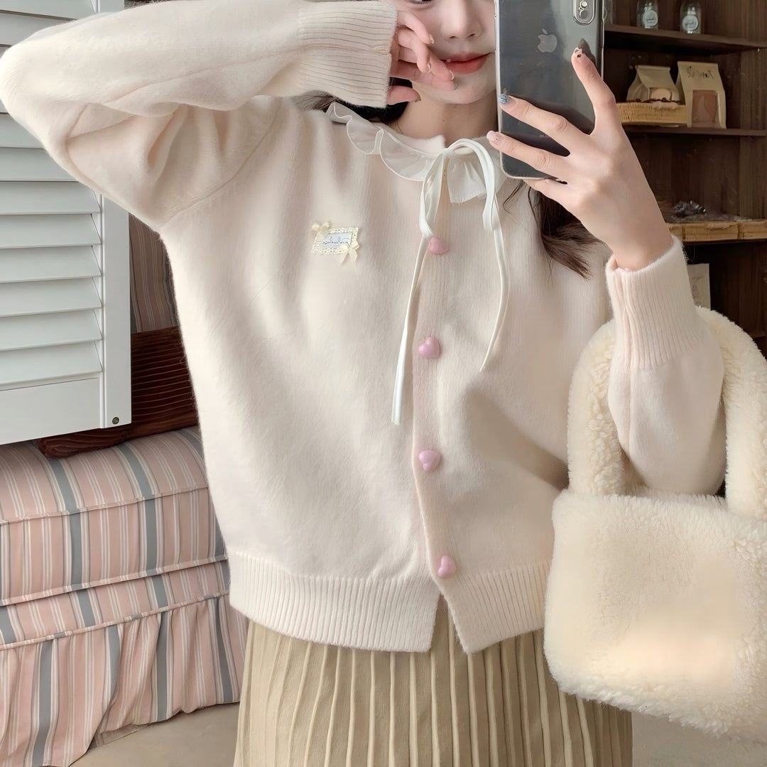 Ladies playful cardigan with ruffle detail and pearl-like buttons Lune London