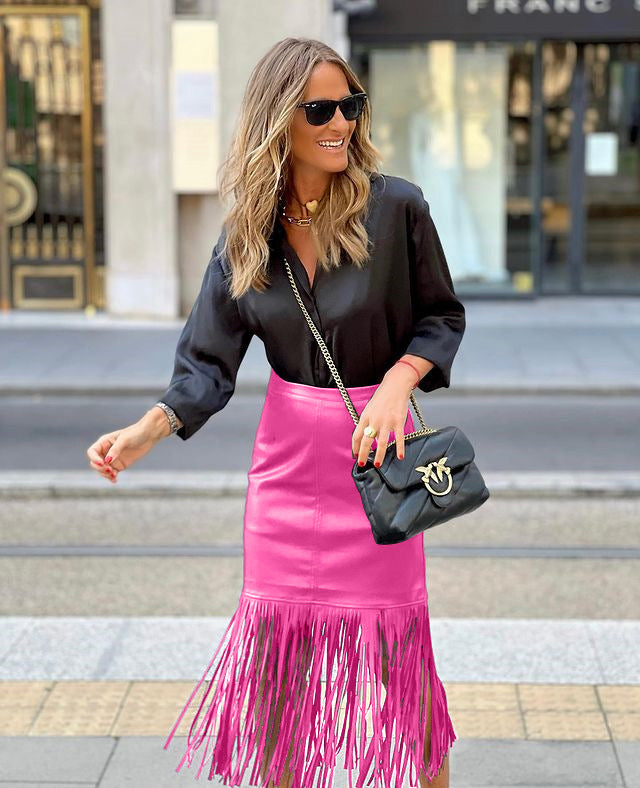 Women's fuchsia fringe skirt made of faux leather with a fitted silhouette and swinging design