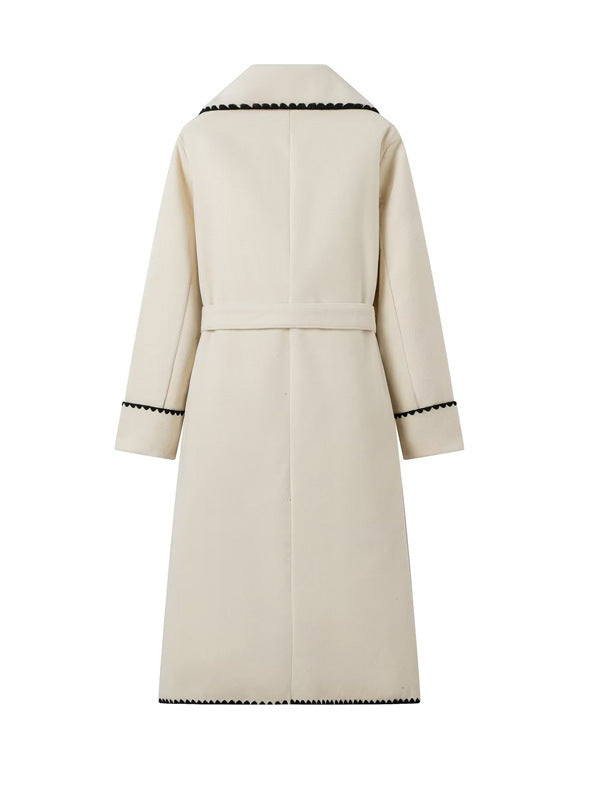 Elegant long coat for women with a tie belt and contrasting piping Lune London