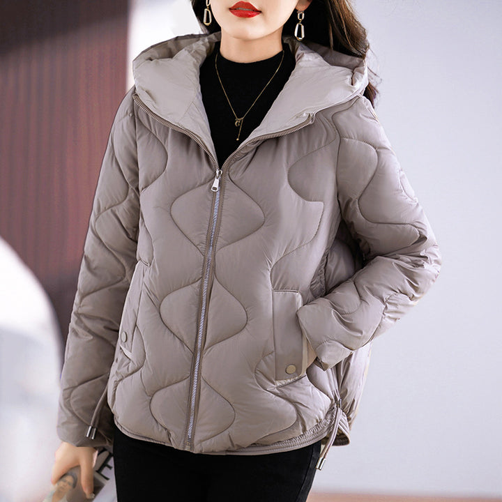 Insulated quilted jacket for women with high collar and practical zip pockets Lune London