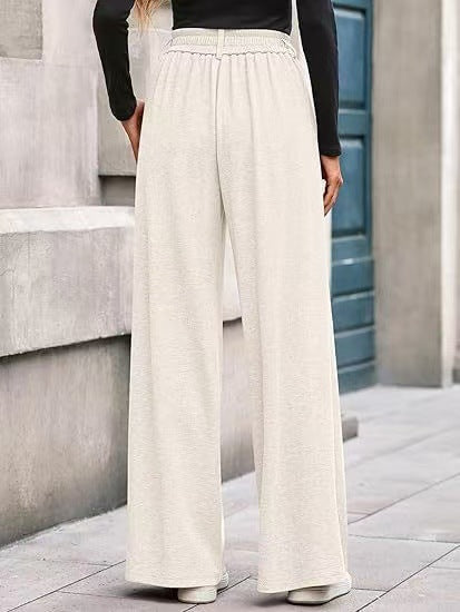 Loose fabric trousers for women with high waist and practical pockets. Chic and style