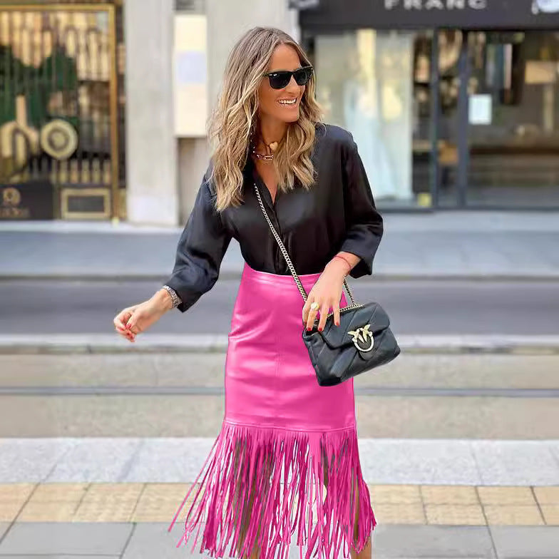 Women's fuchsia fringe skirt made of faux leather with a fitted silhouette and swinging design