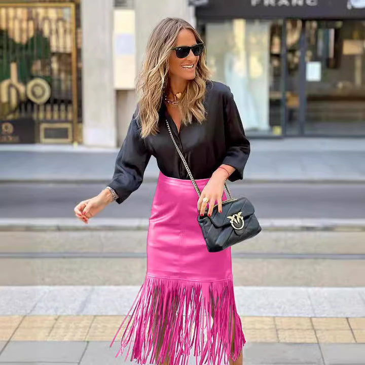 Women's fuchsia fringe skirt made of faux leather with a fitted silhouette and swinging design