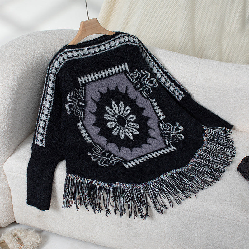 Ladies elegant knitted poncho with artistic pattern and fringe finish Lune London