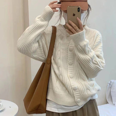 Women's chunky knit sweater with button placket and elegant cable pattern Lune London
