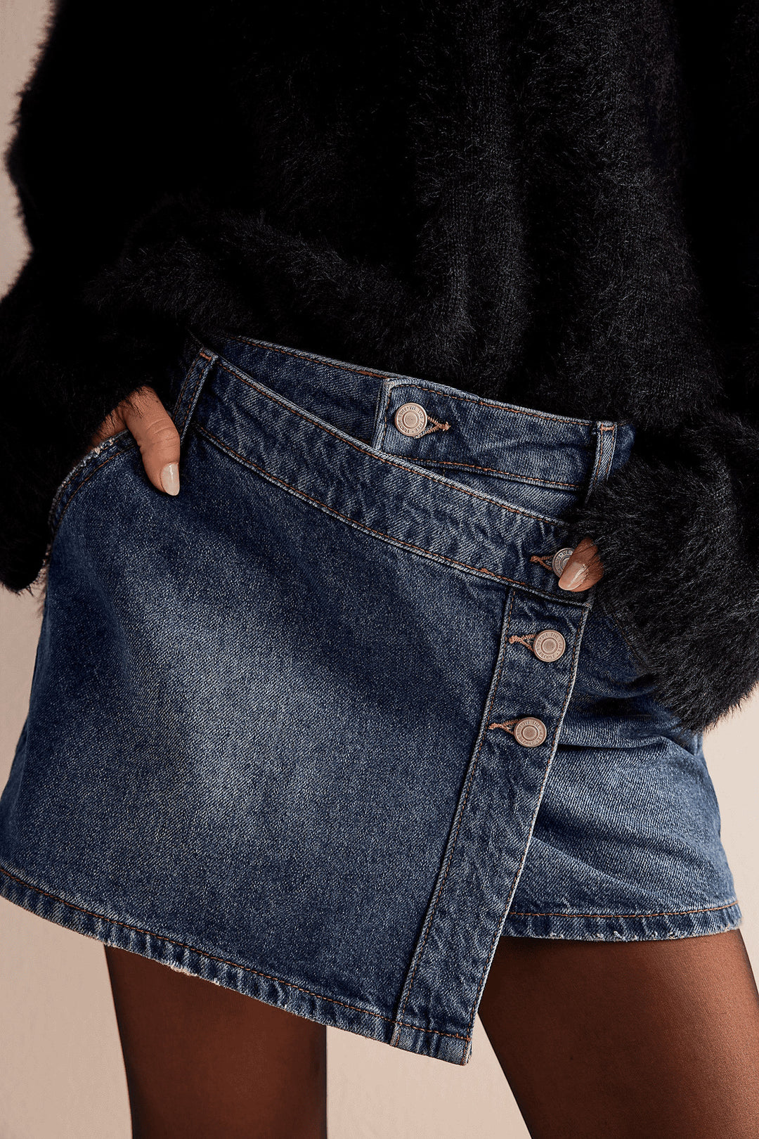 Women's fashionable A-line denim skirt with asymmetric button design and practical pockets Lune London