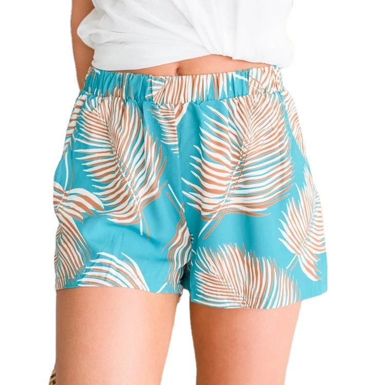 Women's breezy beach shorts with elastic waistband and tropical leaf design