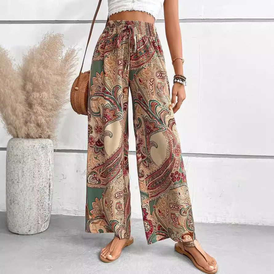 Wide palazzo pants for women with a colorful paisley pattern and an elastic waistband Lune London