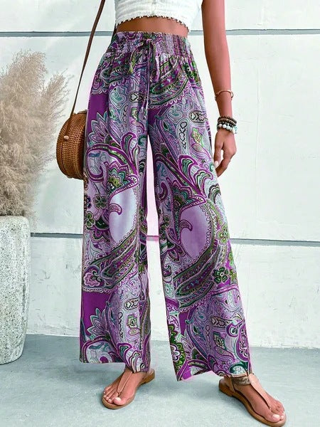 Wide palazzo pants for women with a colorful paisley pattern and an elastic waistband Lune London